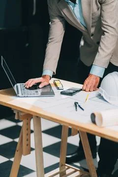 Team Engineers with draft plan of building on constructing site. Engineer w.. Fotos de archivo
