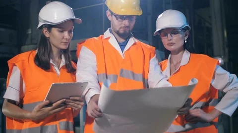 Team of engineers with drawings 스톡 동영상 77553690