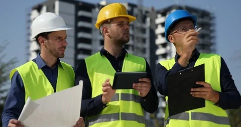 Team of Engineers Have Conversation about Project of Building Under Construction Stock Footage 88007790