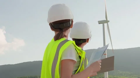 A team of engineers in highvisibility vests and helmets is conducting a safety Stock Footage 284711299
