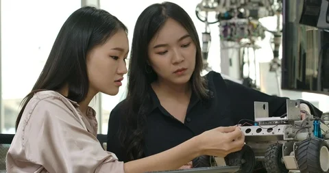 Team of engineers programming for robotics in workshop. Video stock 111830973