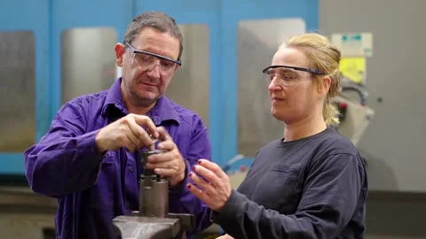 Team of engineers repairing a machine in a cnc factory Stock Footage 258805495