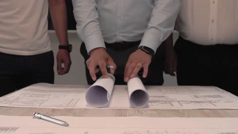 Team of engineers reveals a huge sheet with the technical design plan Stock Footage 212380929
