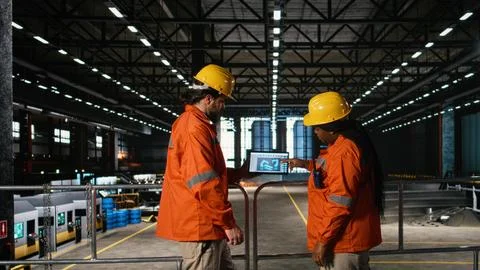 Team of engineers, robotics software, laptop tools, heavy industry workshop Stockfoto's