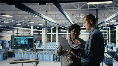 Team of engineers in server hub optimizing deep learning AI systems Video stock 314805574