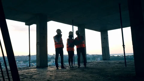 A team of engineers talking on a construction site. Stock Footage 117633938