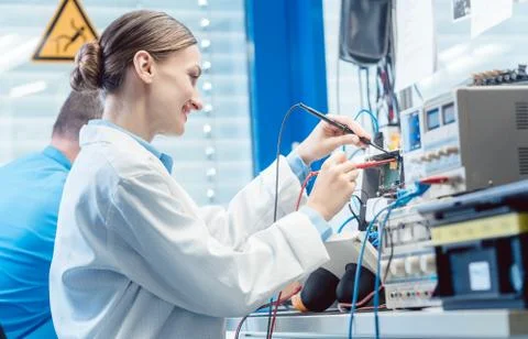 Team of engineers testing and measuring an electronic product in the lab Stock Photos