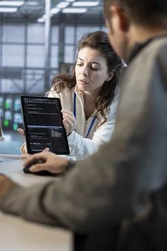 Team on engineers using tablet in data center Stock Photos