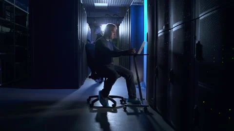 Team of engineers working with devices and checking hardware at big data center Stock Footage 165586411