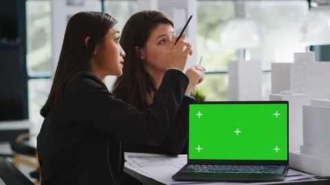 Team of engineers working with greenscreen display on pc Stock Photos