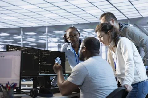 Team of engineers working in server farm, using PCs to analyze data 스톡 사진
