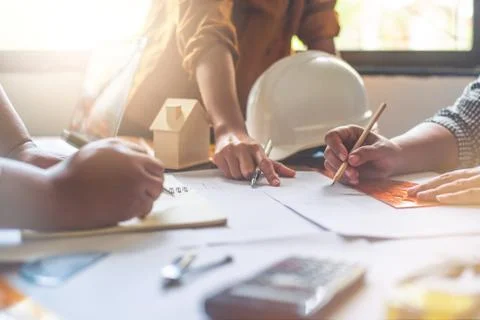 Team of engineers working together in a architect office. Stock Photos