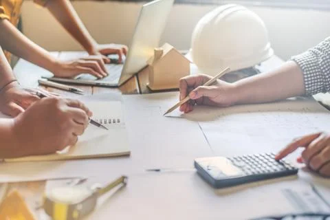 Team of engineers working together in a architect office. Stock Photos