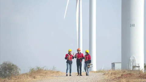 Team of engineers working on wind turbines in a wind farm Video stock 264223967