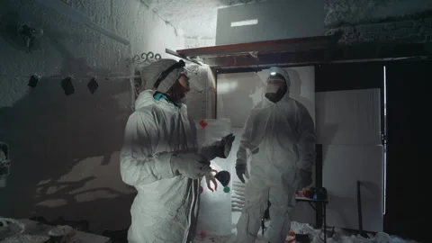 Team examines hazardous environment carefully. Experts evaluate radiation Video stock 342749428