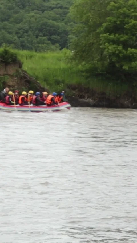 Team of experienced athletes sailing down the river on rafting boats, expedition Stock Footage 244066987