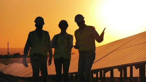 Team of experts are walking next to outdoors solar panels Stock Footage 146523757