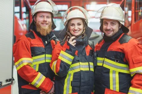 Team of fire fighters looking into camera Stock Photos