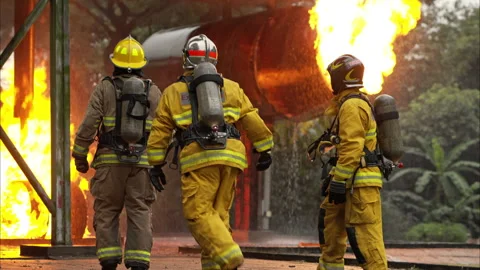A team of firefighters in full protective gear stands together Video stock 326218770
