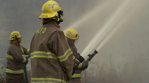 A team of firefighters using high pressure hoses Stock Footage 59221876