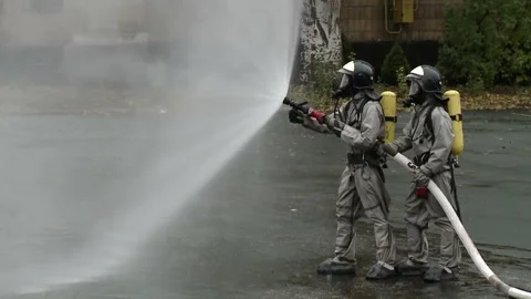 A team of firefighters using high pressure hoses Stock-Footage 85715487