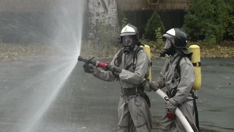 A team of firefighters using high pressure hoses Stock-Footage 85715834