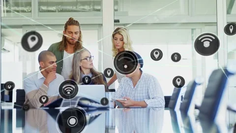 Team of five working around laptop and phone at table, icon appearing and Stock Footage 333904690