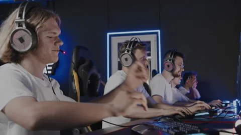 Team of gamers put on headsets at PC computer club, cyber sport tournament. E Stock-Footage 266397105