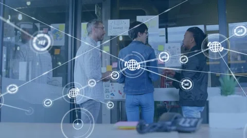 Team at glass, center moving notes, expanding network overlay with chart icons Stock Footage 332901728