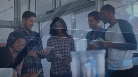 Team grouping around devices in office tilting phone sparking biz review with UI Stock Footage 329611323