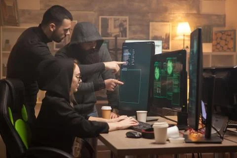 Team of hackers pointing on computer screen 스톡 사진