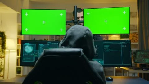 Team of hackers using computer with green screen mockup Foto stock