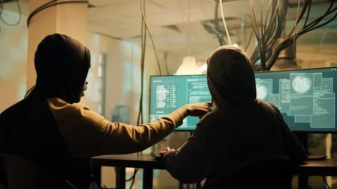 Team of hackers using trojan virus to exploit computer server Stock Photos