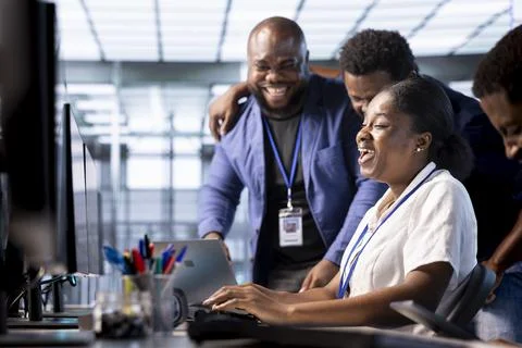Team of happy engineers laughing in data center office Stock Photos