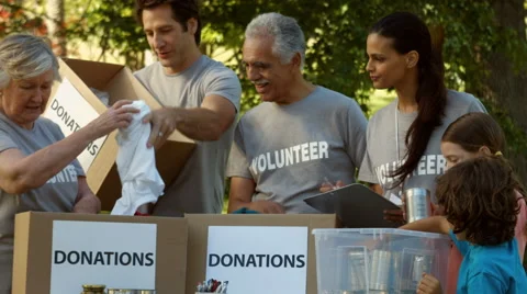 Team of happy volunteers collecting donations Stock Footage
