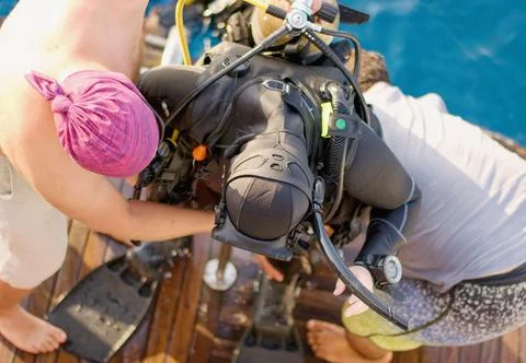 Team help and assistance to heavy equiped diver after dive. Photos