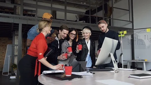 Team of hipster office worker clinking a cup of tea, coffee after finishing work Stock Footage 108327592
