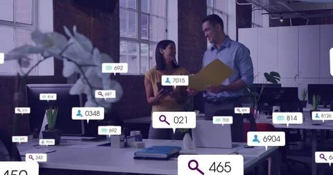 Team holding folder and tablet reviewing docs in office as data callouts Stockfoto's