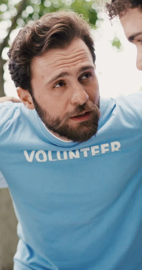 Team, huddle and volunteer with man in park for outreach program, charity drive Stock Footage 321994927
