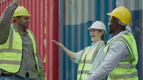 Team of industrial workers join hands for collaboration for successfully working Stock Footage 267828821