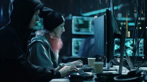 Team of Internationally Wanted Boy and Girl Hackers Organize Advanced Virus Stock Footage 76075569