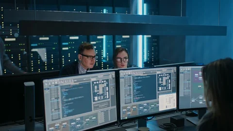 Team of IT Engineers Programmers Talking about Work, Using Computers. Technican Stock Footage 103273111