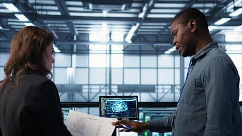 Team of IT professionals looking over data center checkup checklist paperwork 스톡 사진