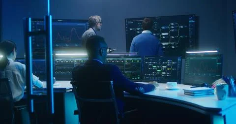 Team of IT technical specialists and software programmers work in monitoring 스톡 사진