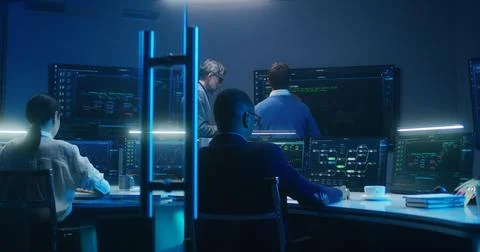 Team of IT technical specialists and software programmers work in monitoring 스톡 사진