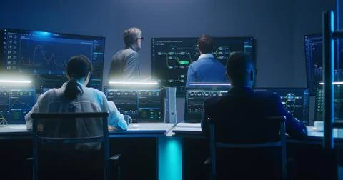 Team of IT technical specialists and software programmers work in monitoring Stock Photos
