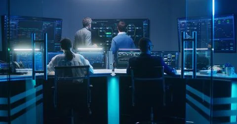 Team of IT technical specialists and software programmers work in monitoring Stock Photos