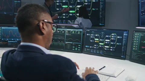 Team of IT technical specialists work in monitoring office Stock Footage 244411893