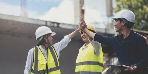 Team job of teamwork engineer work together in a construction site with business Stock Photos