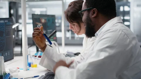 Team of lab technicians using chemical solutions, creating mixtures Stock Footage 320146614